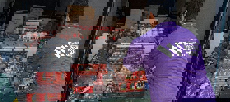 Ramadan Daily Sadaqah stacks of food parcels prepared for distribution.