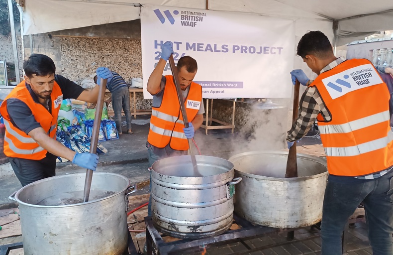sadaqah in ramadan hadith Volunteers in orange vests stir large pots of food at a humanitarian hot meals project.