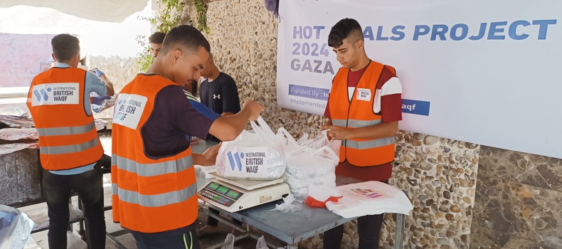 sadaqah in ramadan hadith  Volunteers in orange vests pack and distribute food bags as part of a humanitarian hot meals